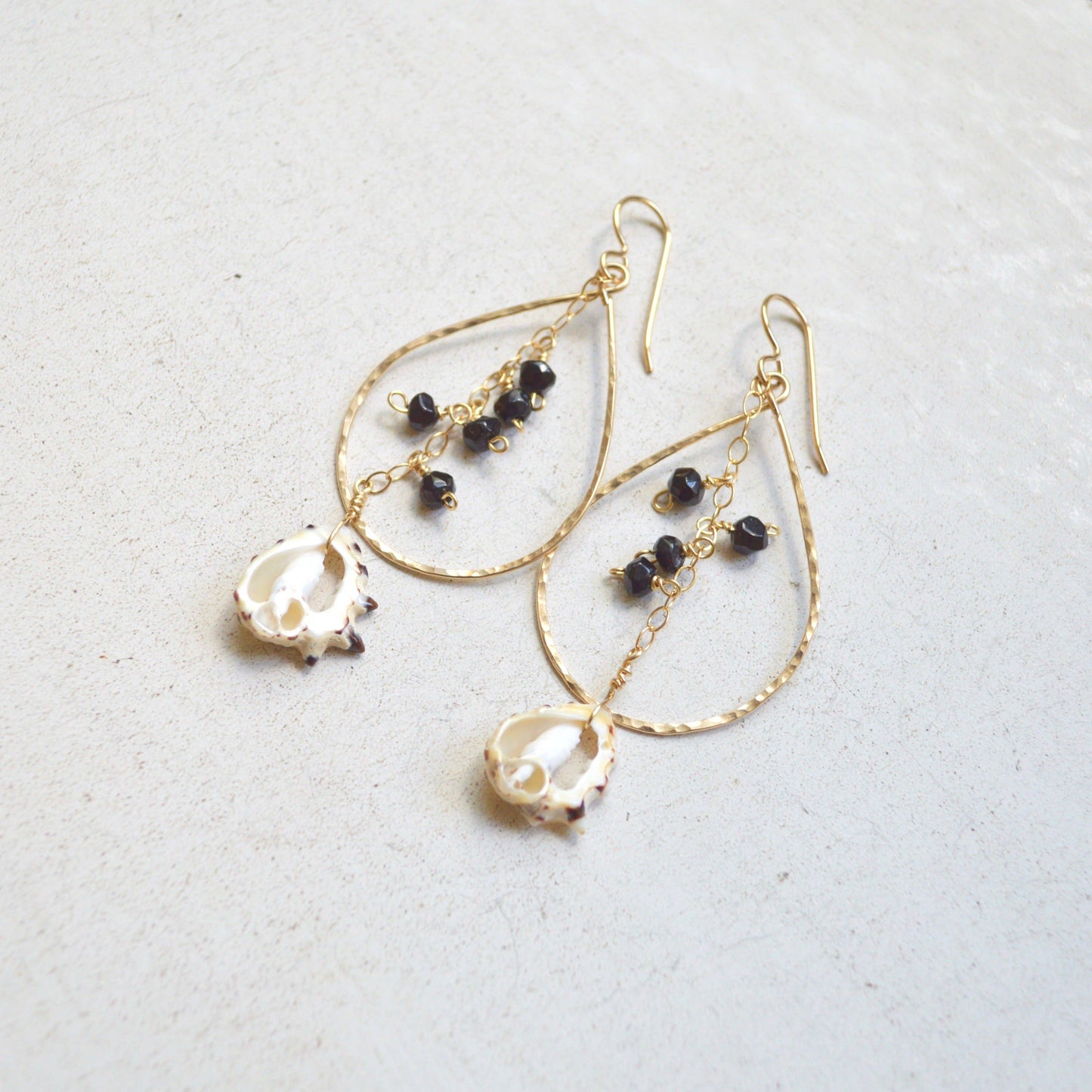 Black Onyx & Drupa Shell Teardrop Earrings in Gold