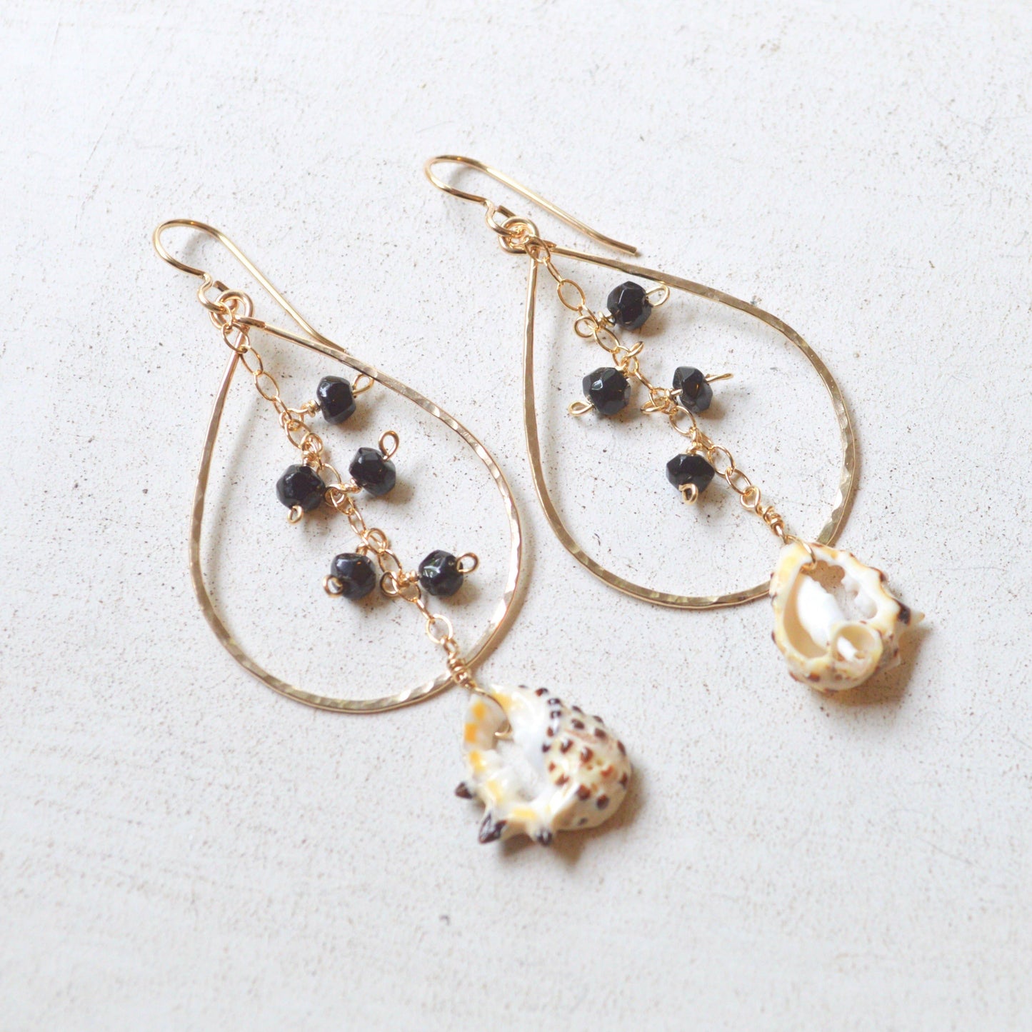 Black Onyx & Drupa Shell Teardrop Earrings in Gold